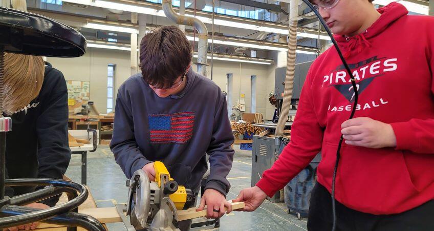 Students use circular saws to cut wood